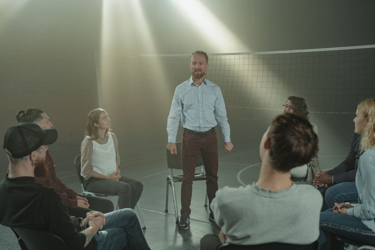why-choose-us A supportive group therapy session in a sunlit room, highlighting connection and healing.